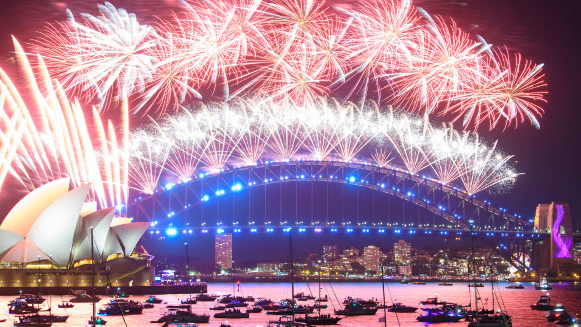 Fireworks are seen over the Sydney harbor during New Year celebrations on Jan. 1, 2022 in Sydney, Australia. New Year's Eve celebrations continue to be somewhat different as some Covid-19 restrictions remain in place due to the ongoing coronavirus pandemic.