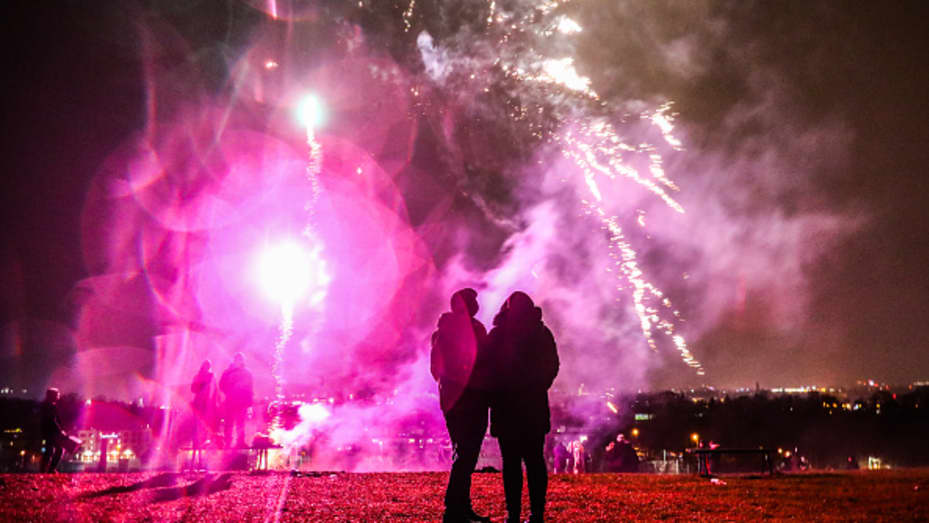 People celebrate New Year at Krakus Mound in Krakow, Poland on Jan. 1, 2022.