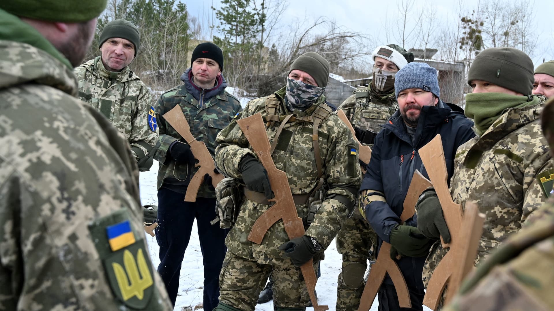 Ukrainian Territorial Defense Forces, the military reserve of the Ukrainian Armes Forces, holding wooden replicas of Kalashnikov rifles, take part in a military exercise near Kiev on December 25, 2021.