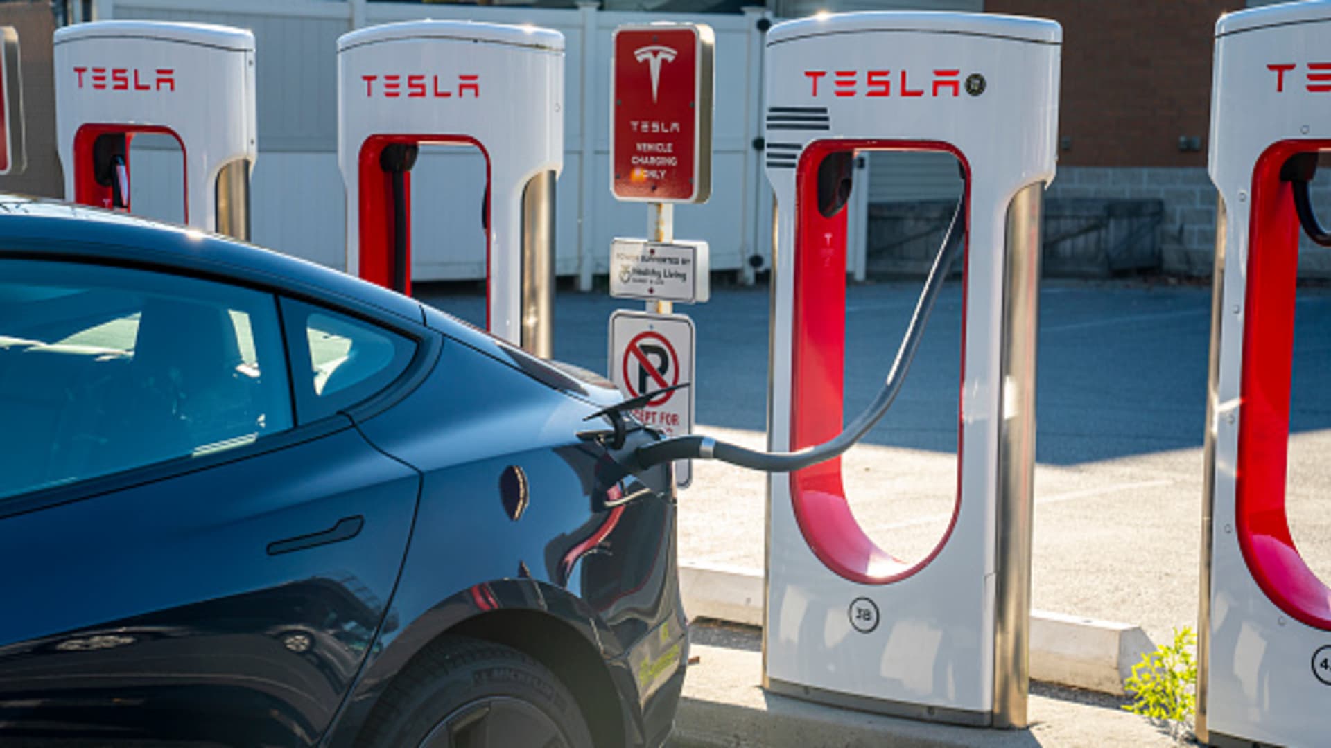 An electric Tesla car recharges at a Tesla kiosk November 7, 2021 in South Burlington, Vermont.