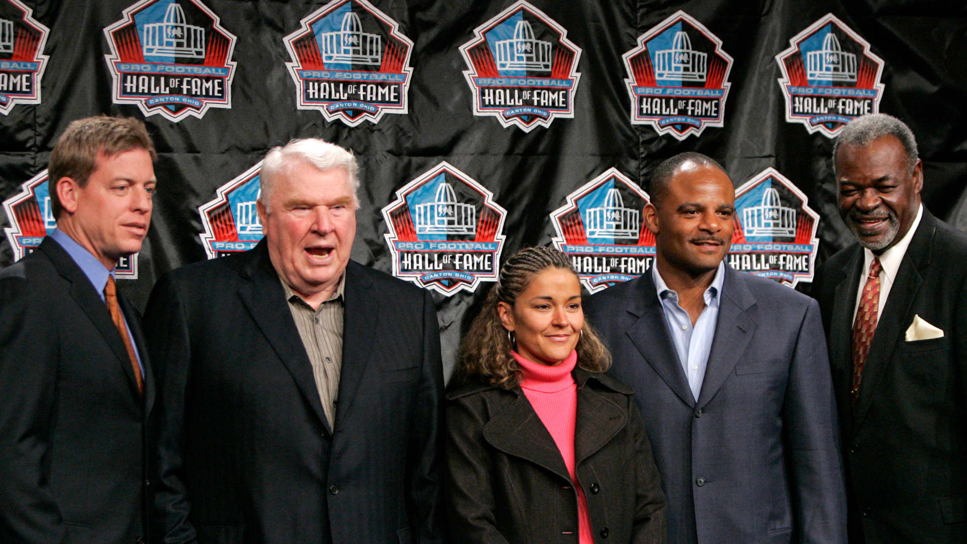 Newly inducted members of the NFL Hall of Fame stand after a news conference in Detroit, Michigan February 4, 2006. (L to R) Former quarterback of the Dallas Cowboys Troy Aikman, former Oakland Raiders coach John Madden, Sara White, the wife of former Green Bay Packer Reggie White, former quarterback of the Houston Oilers Warren Moon and Rayfield Wright of the Dallas Cowboys.