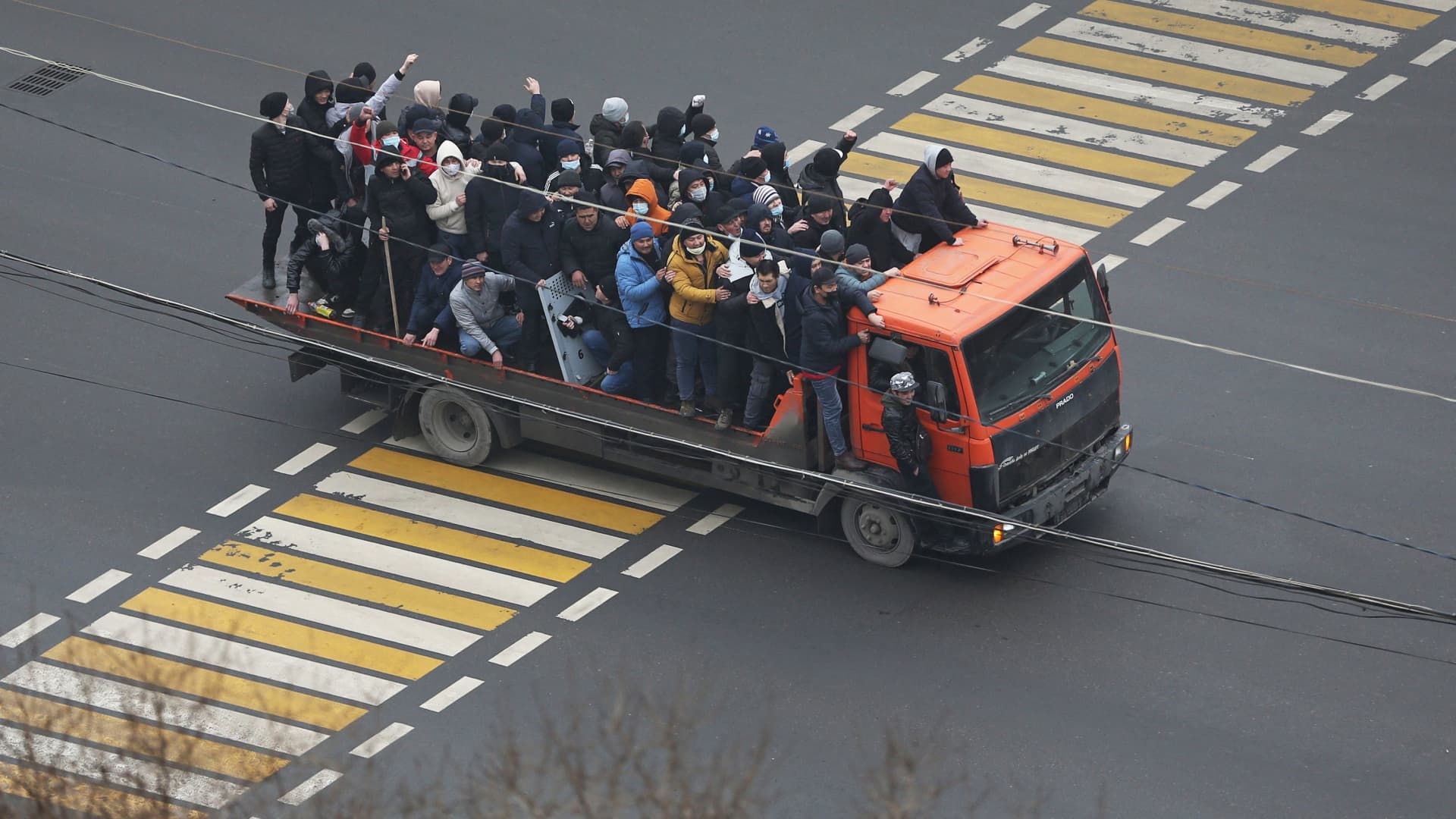 Demonstrators ride a truck during a protest triggered by fuel price increase in Almaty, Kazakhstan January 5, 2022.