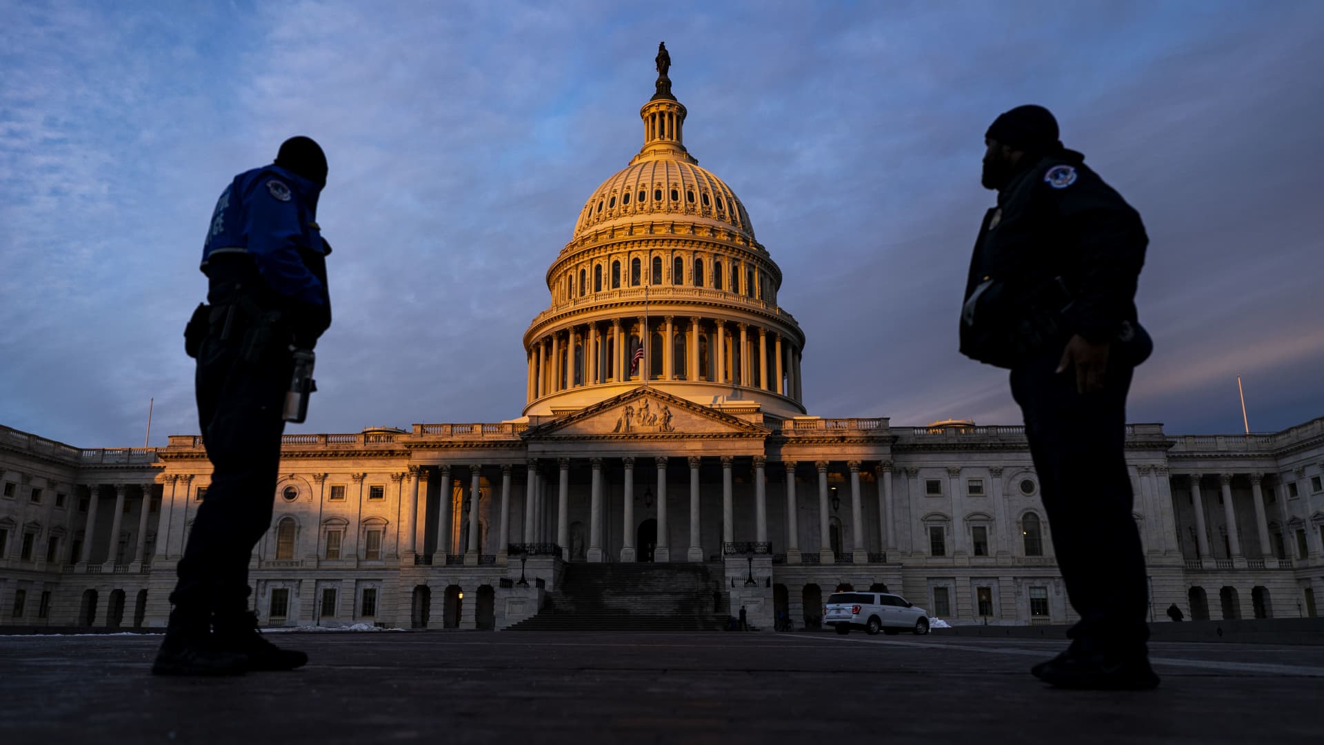 Capitol Police Officers stand on the East Plaza of the Capitol Campus as the dome of the U.S. Capitol Building is illuminated by the rising sun on Capitol Hill on Thursday, Jan. 6, 2022 in Washington, DC.