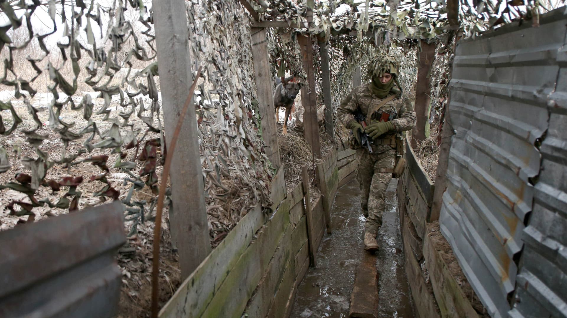 Ukrainian Military Forces serviceman walks a trench on the front line with Russia-backed separatists near Avdiivka, Donetsk, southeastern Ukraine, on January 9, 2022.