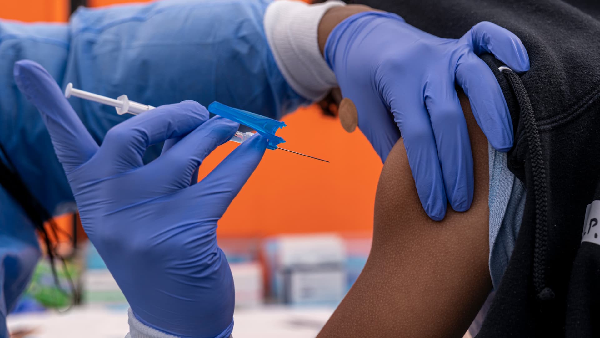A healthcare worker administers a Pfizer-BioNTech Covid-19 vaccine to a child at a testing and vaccination site in San Francisco, California, U.S., on Monday, Jan. 10, 2022.