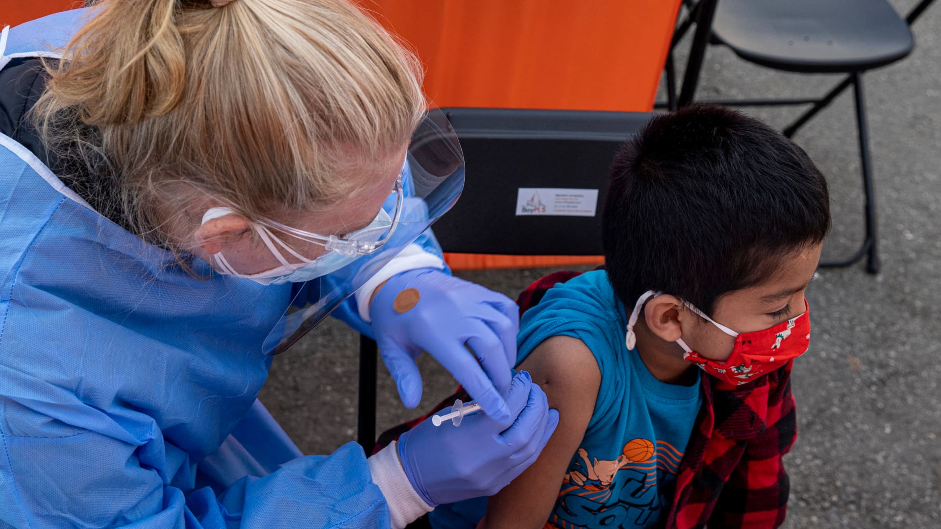 A healthcare worker administers a Pfizer-BioNTech Covid-19 vaccine to a child at vaccination site in San Francisco, California, U.S., on Monday, Jan. 10, 2022.