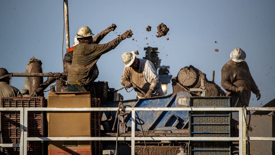 Workers remove clay batches while extracting mud from the drilling well at Controlled Thermal Resources' geothermal energy and lithium plant in California on November 9, 2021.