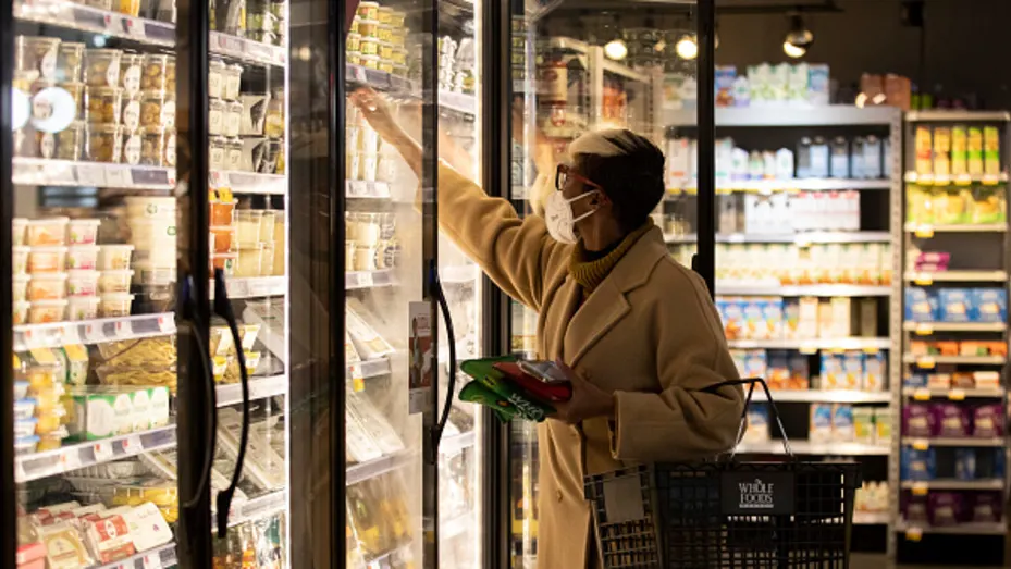 A customer selects food from a freezer at a supermarket on January 12, 2022 in New York City.