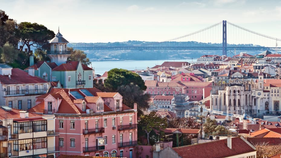 Lisbon's skyline, showing the city's Ponte 25 de Abril spanning the river Tagus.