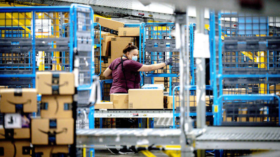 A worker sorts out parcels in the outbound dock at Amazon fulfillment center in Eastvale on Tuesday, Aug. 31, 2021.