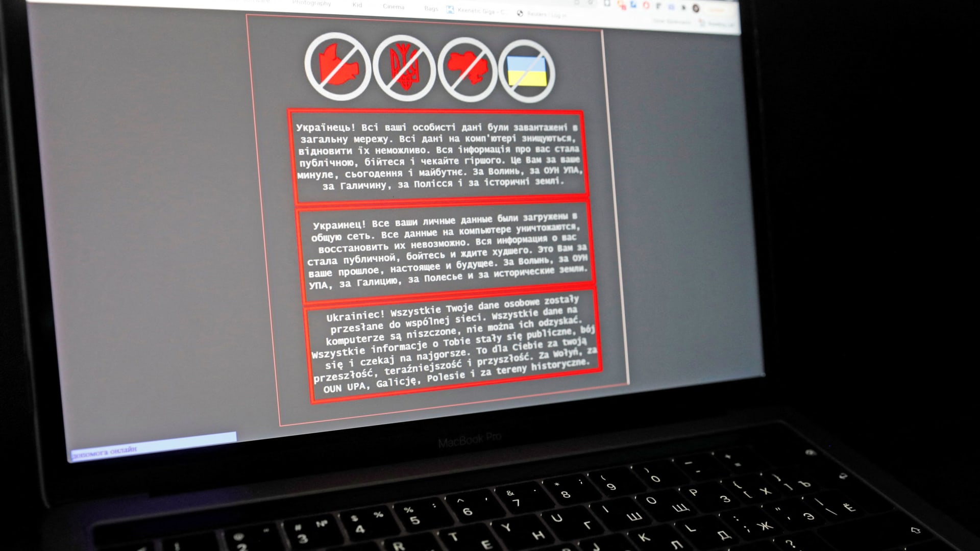 A laptop screen displays a warning message in Ukrainian, Russian and Polish, that appeared on the official website of the Ukrainian Foreign Ministry after a massive cyberattack, in this illustration taken January 14, 2022.