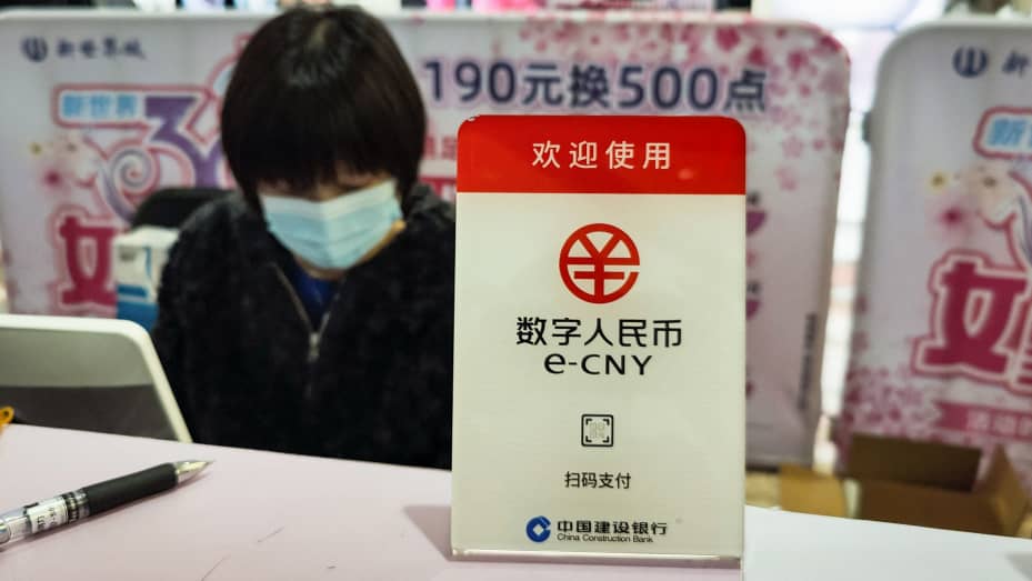 A sign for China's digital currency, the electronic Chinese yuan (e-CNY) is displayed at a shopping mall in Shanghai on March 8, 2021.