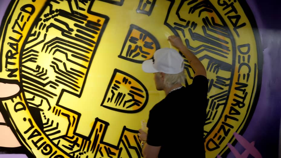Alec Monopoly paints a bitcoin onto a mural at the North American Bitcoin Conference held at the James L Knight Center on January 18, 2022 in Miami, Florida.