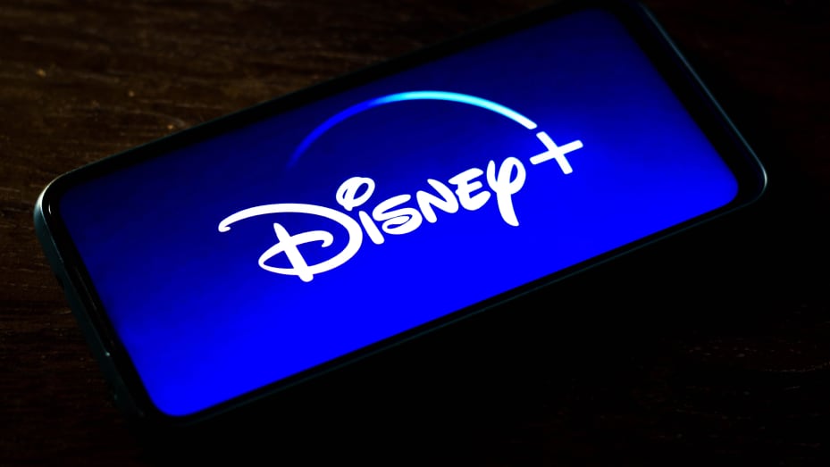 In this photo illustration the Disney+ logo seen displayed on a smartphone screen. Is an online video streaming subscription service owned and operated by Direct-to-Consumer & International, a subsidiary of The Walt Disney Company.
