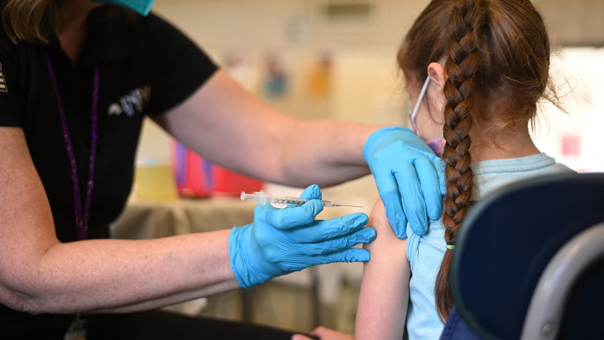 A nurse administers a pediatric dose of the Covid-19 vaccine to a girl at a L.A. Care Health Plan vaccination clinic at Los Angeles Mission College in the Sylmar neighborhood in Los Angeles, California, January 19, 2022.
