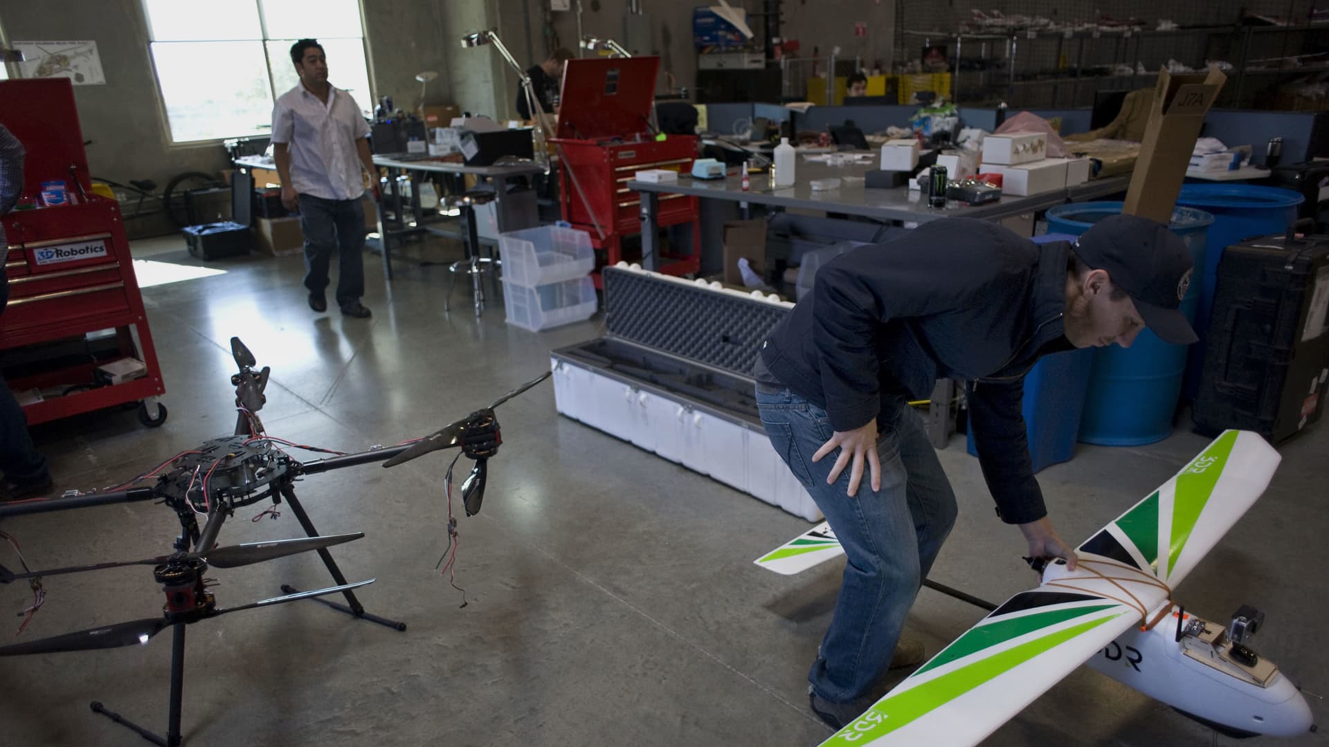 An employee moves a fixed wing unmanned aerial vehicle (UAV) at the 3D Robotics research and development facility in San Diego, California, U.S., on Monday, Jan. 5, 2015.