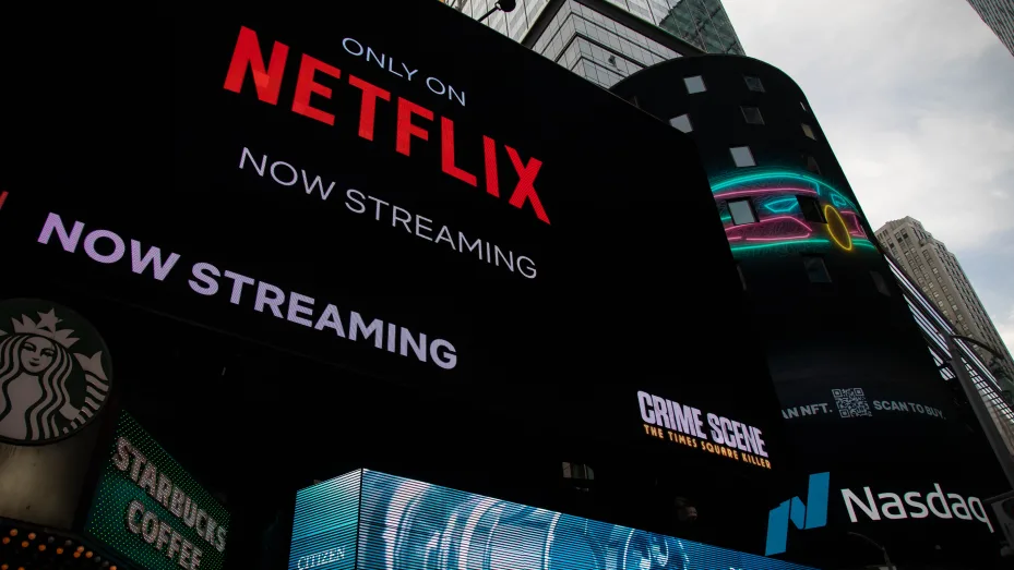 Netflix signage next to the Nasdaq MarketSite in New York, U.S., on Friday, Jan. 21, 2022.