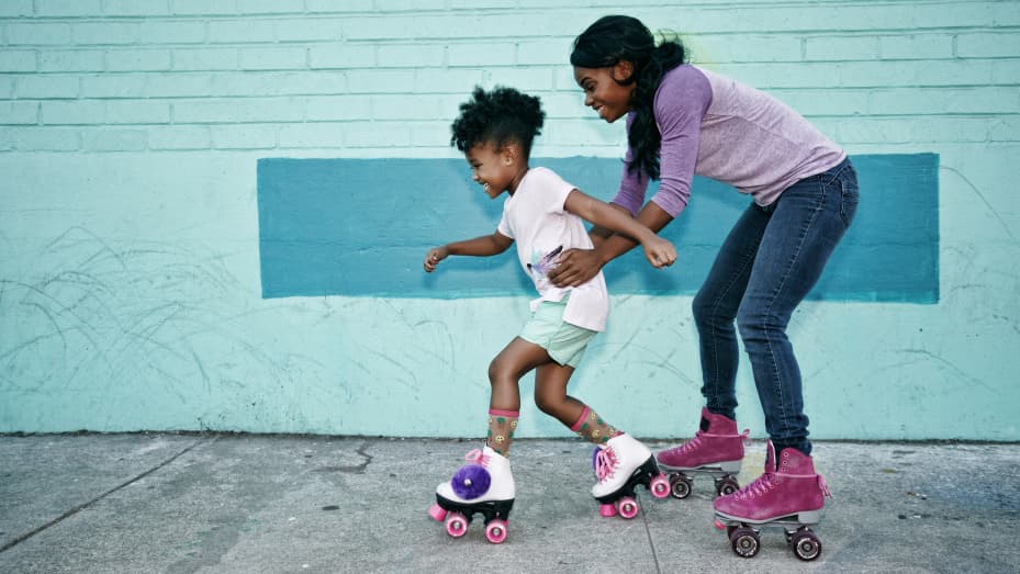 Mother praising daughter while roller skating