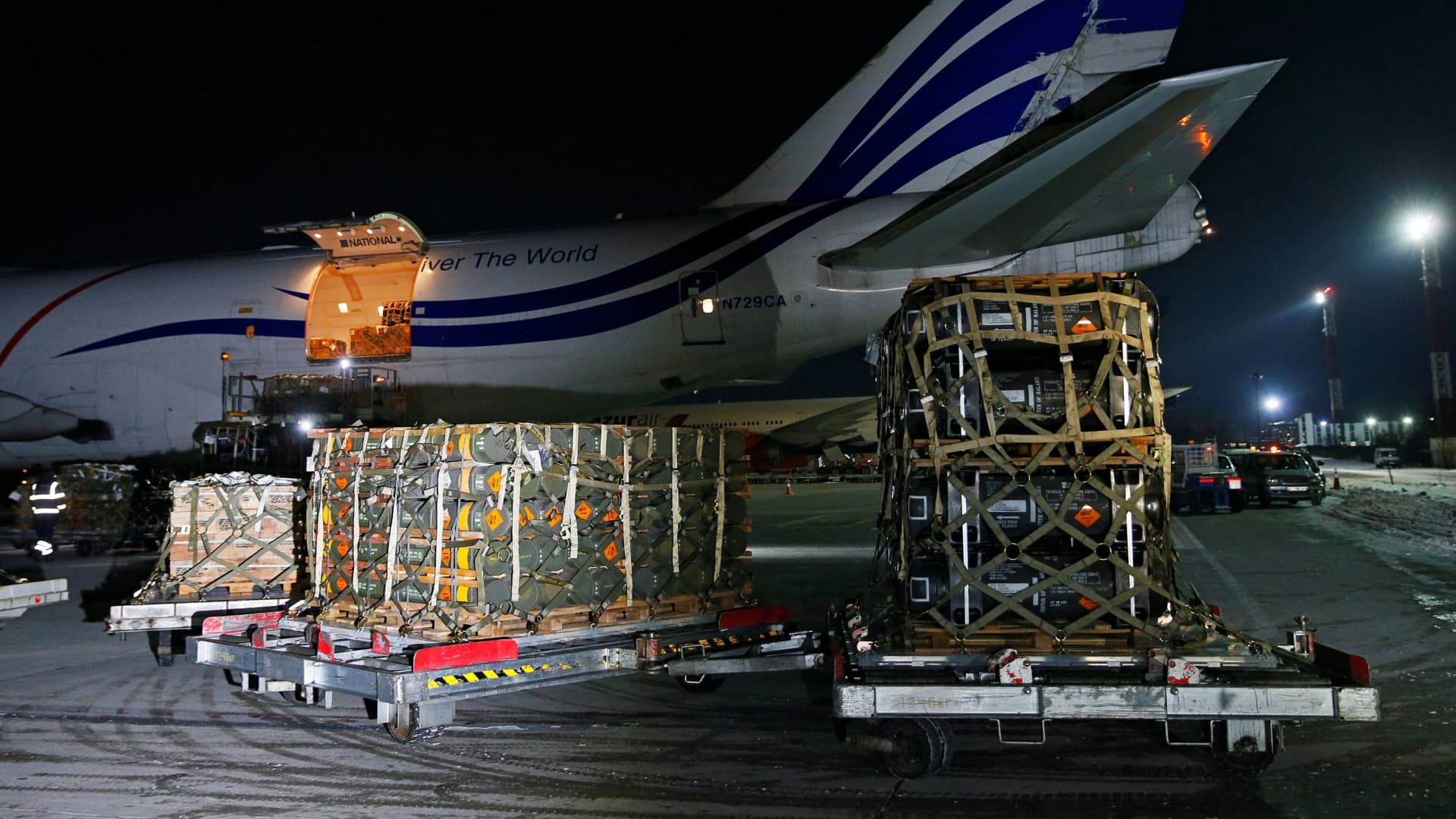 Workers unload a shipment of military aid delivered as part of the United States of America's security assistance to Ukraine, at the Boryspil International Airport outside Kyiv, Ukraine January 25, 2022.