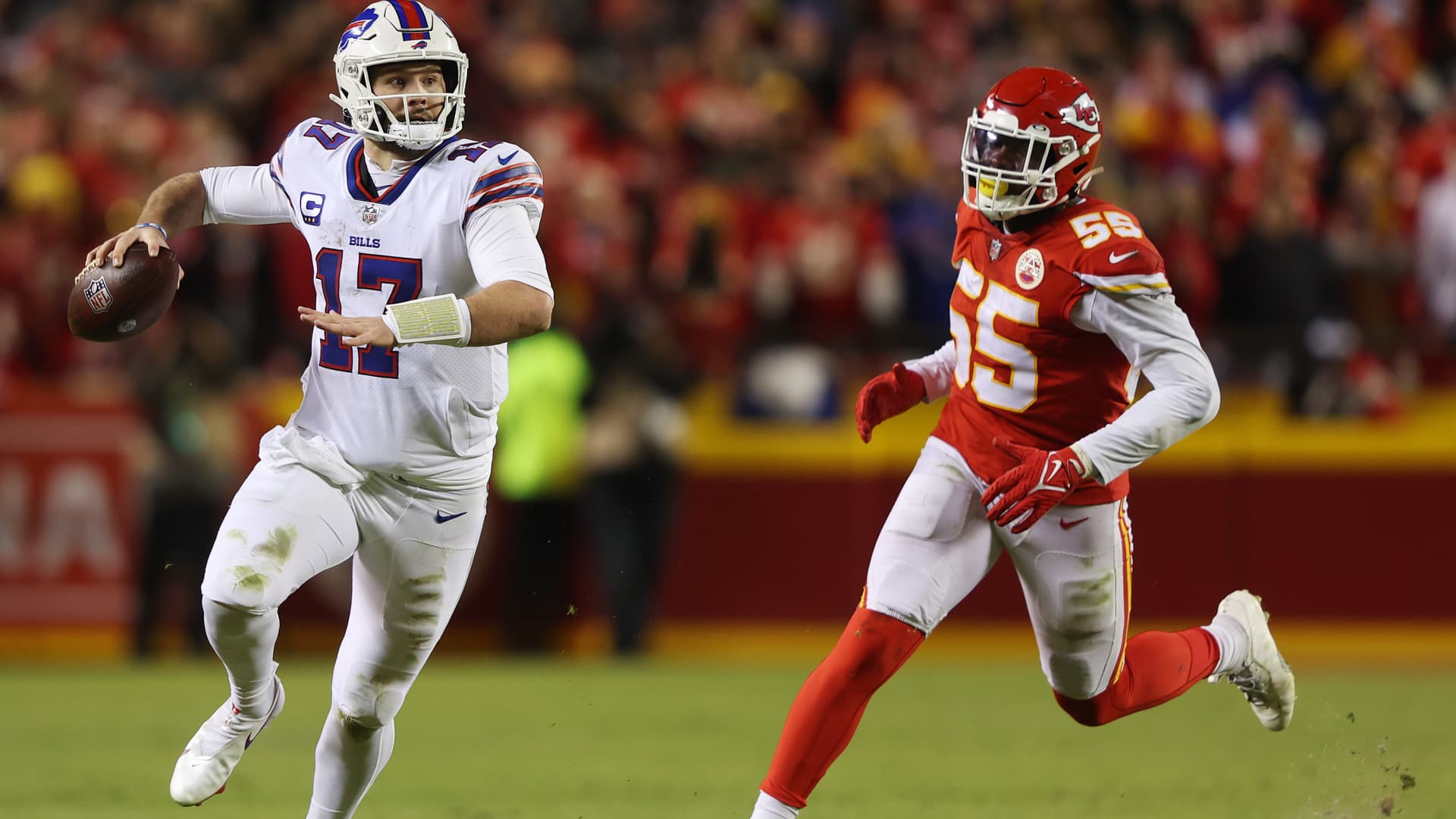Josh Allen #17 of the Buffalo Bills runs with the ball as Frank Clark #55 of the Kansas City Chiefs defends during the AFC Divisional Playoff game at Arrowhead Stadium on January 23, 2022 in Kansas City, Missouri.