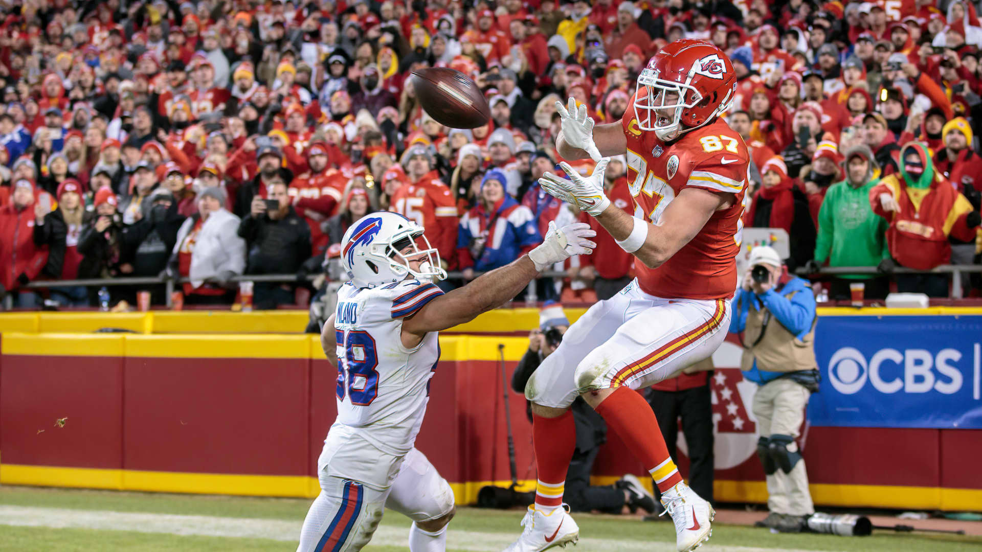 Kansas City Chiefs tight end Travis Kelce (87) reaches for the game winning reception over Buffalo Bills outside linebacker Matt Milano (58) during the AFC Divisional Round playoff game on January 23rd, 2022 at Arrowhead Stadium in Kansas City, Missouri.