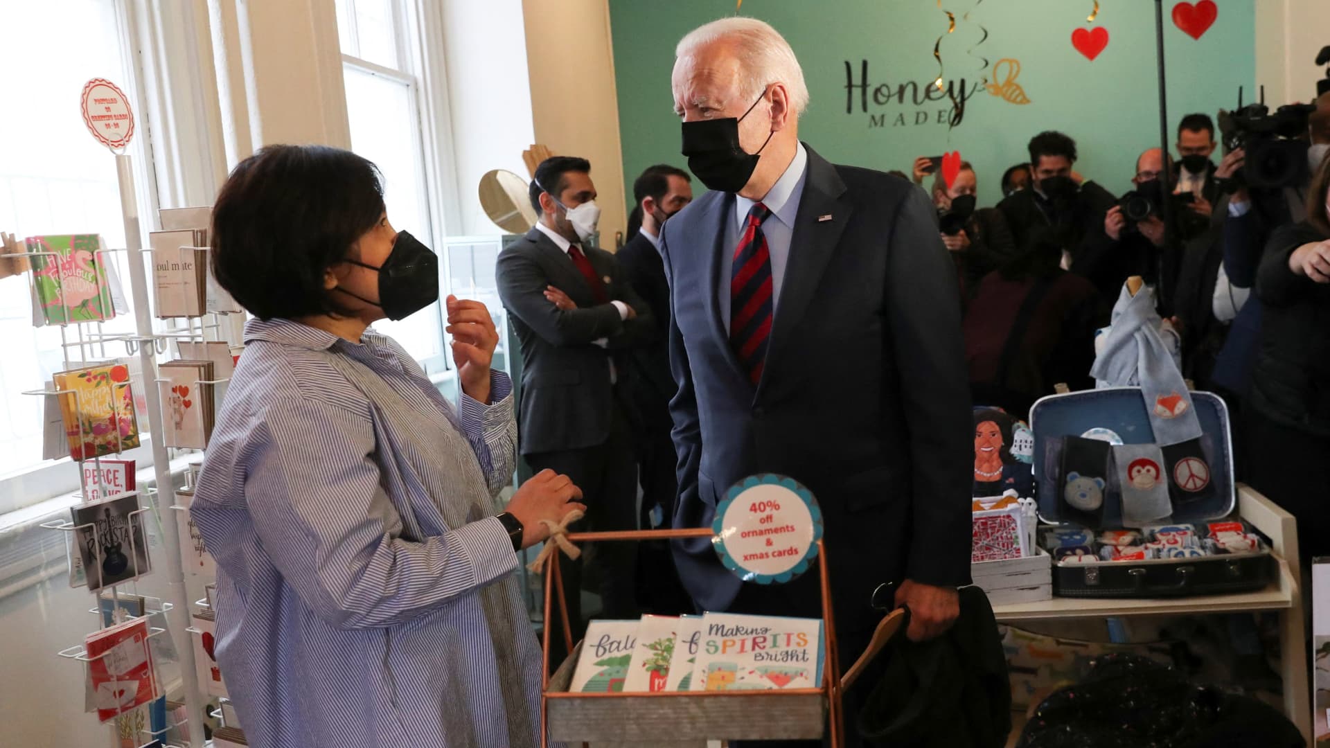 U.S. President Joe Biden talks with shop owner Viboonrattana Honey as he pays a visit to a small store called Honey Made that sells handmade clothing and gifts on Capitol Hill in Washington, U.S., January 25, 2022.