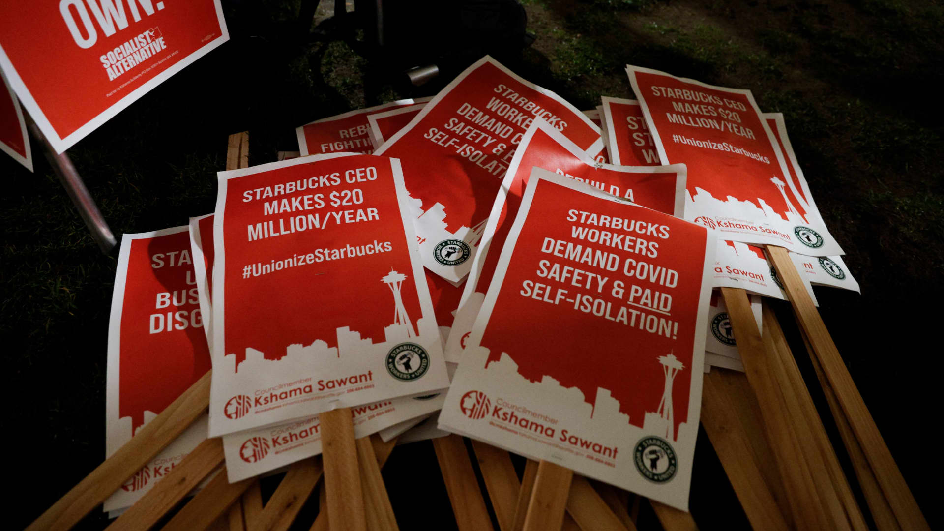 Picket signs are pictured at a rally in support of workers of two Seattle Starbucks locations that announced plans to unionize, during an evening rally at Cal Anderson Park in Seattle, on Jan. 25, 2022.