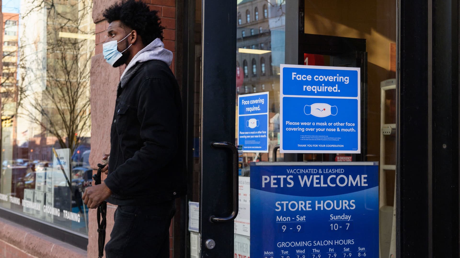 A person wearing a face mask leaves a store on January 26, 2022 in New York City.