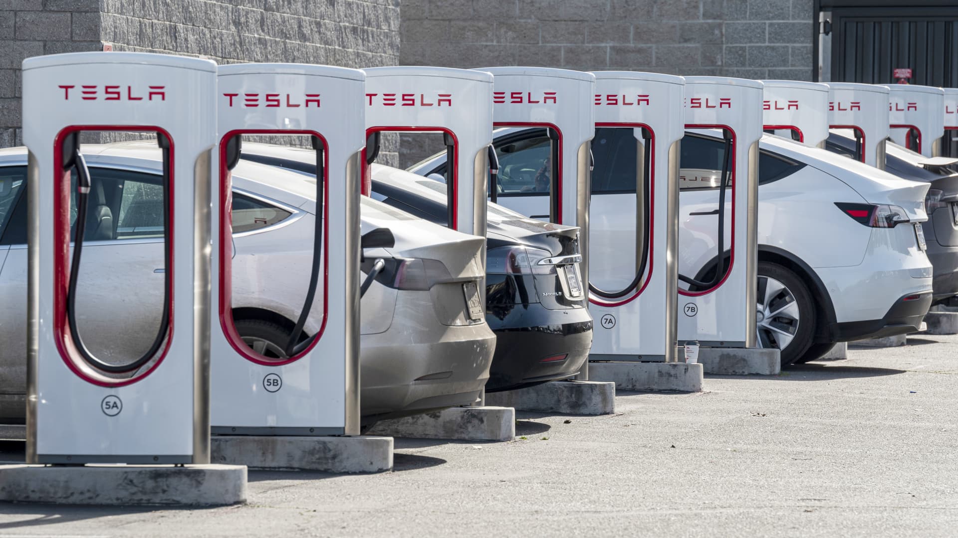 Tesla vehicles at charging stations at a dealership in Rocklin, California, U.S., on Friday, Jan. 21, 2022.