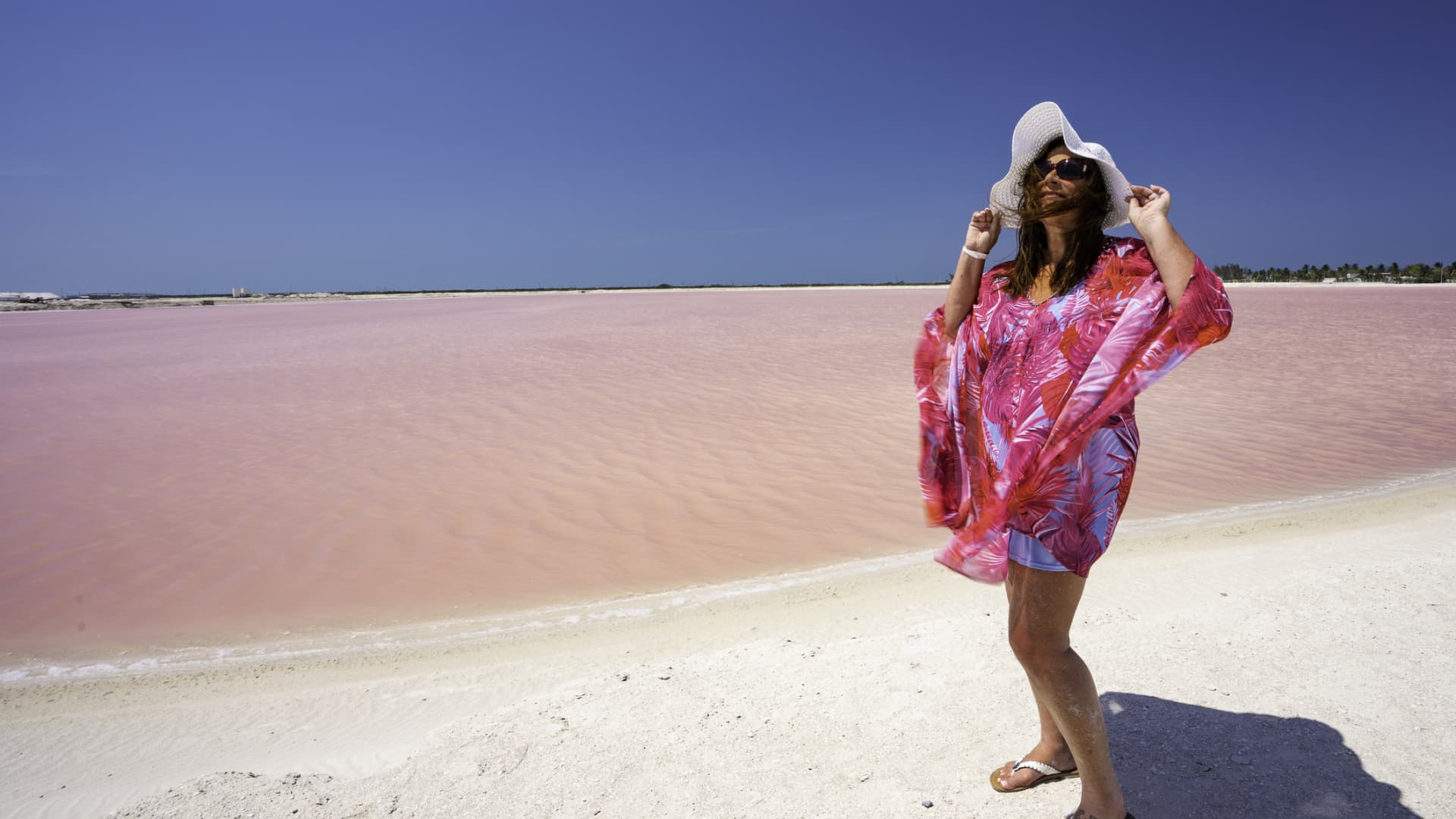 A tourist stands next to the algae-tinted pink lakes of Los Colorados in Yucatan, Mexico.