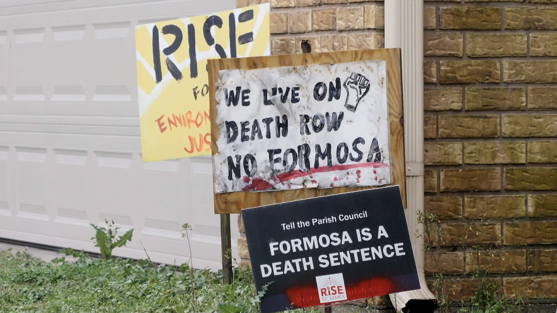 Signs protesting the construction of a Formosa Plastics petrochemical facility in St. James Parish, Louisiana