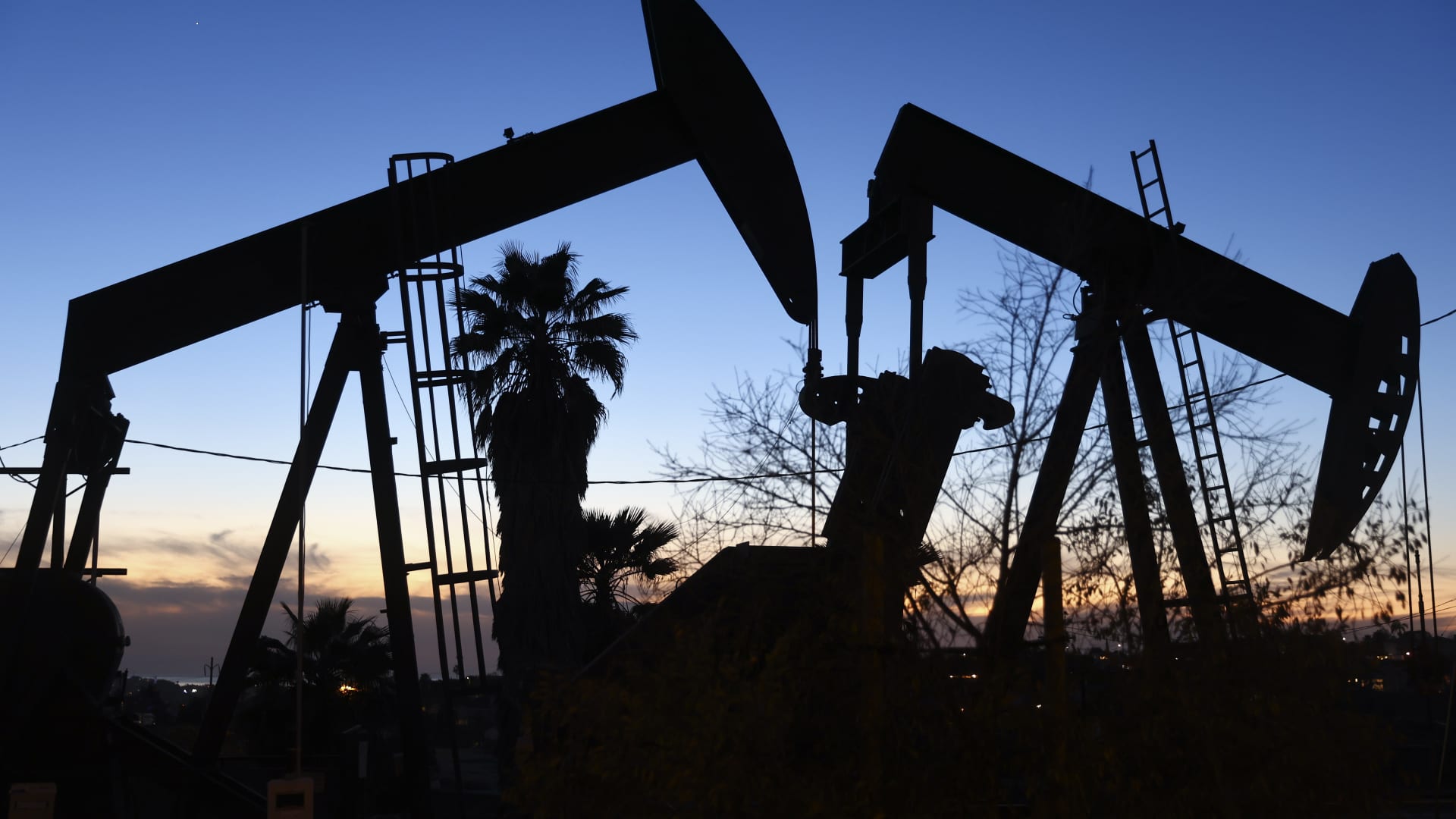 An oil pumpjack (L) operates as another (R) stands idle in the Inglewood Oil Field on January 28, 2022 in Los Angeles, California.