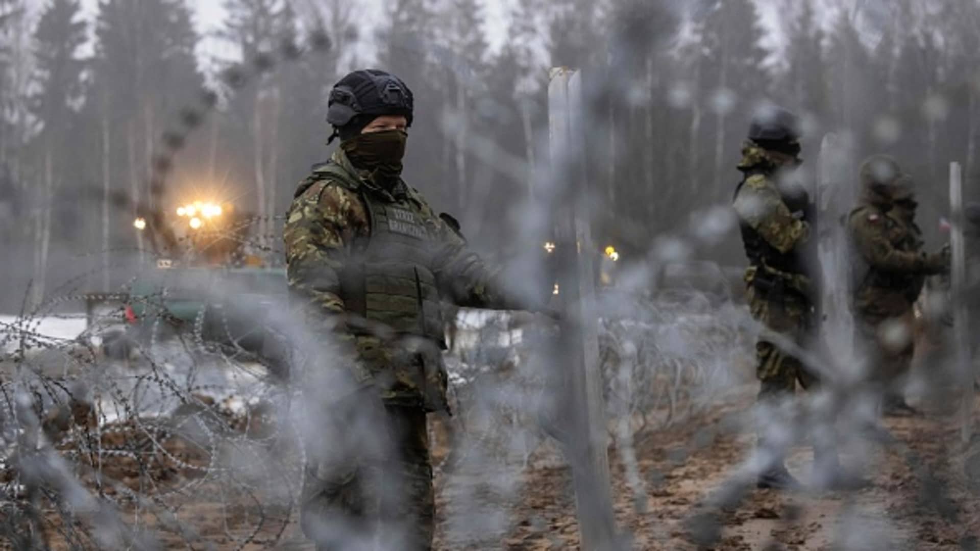 Border guard officers and soldiers are seen during the construction of a border wall along the Polish-Belarus border in Tolcze, Sokolka County, Podlaskie Voivodeship, in north-eastern Poland on January 27, 2022.