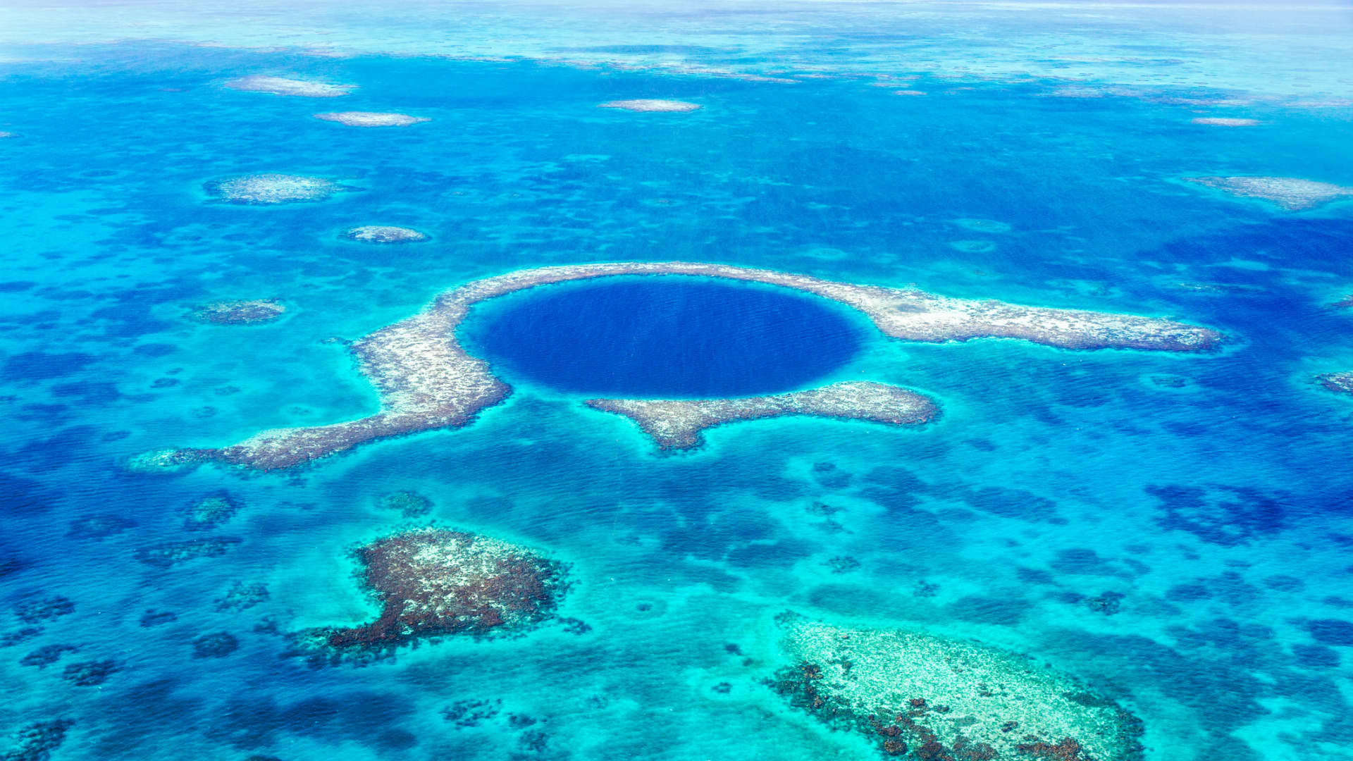 Belize's new insurance requirement for visitors begins Feb. 15, 2022. Pictured, the Blue Hole at Lighthouse Reef.