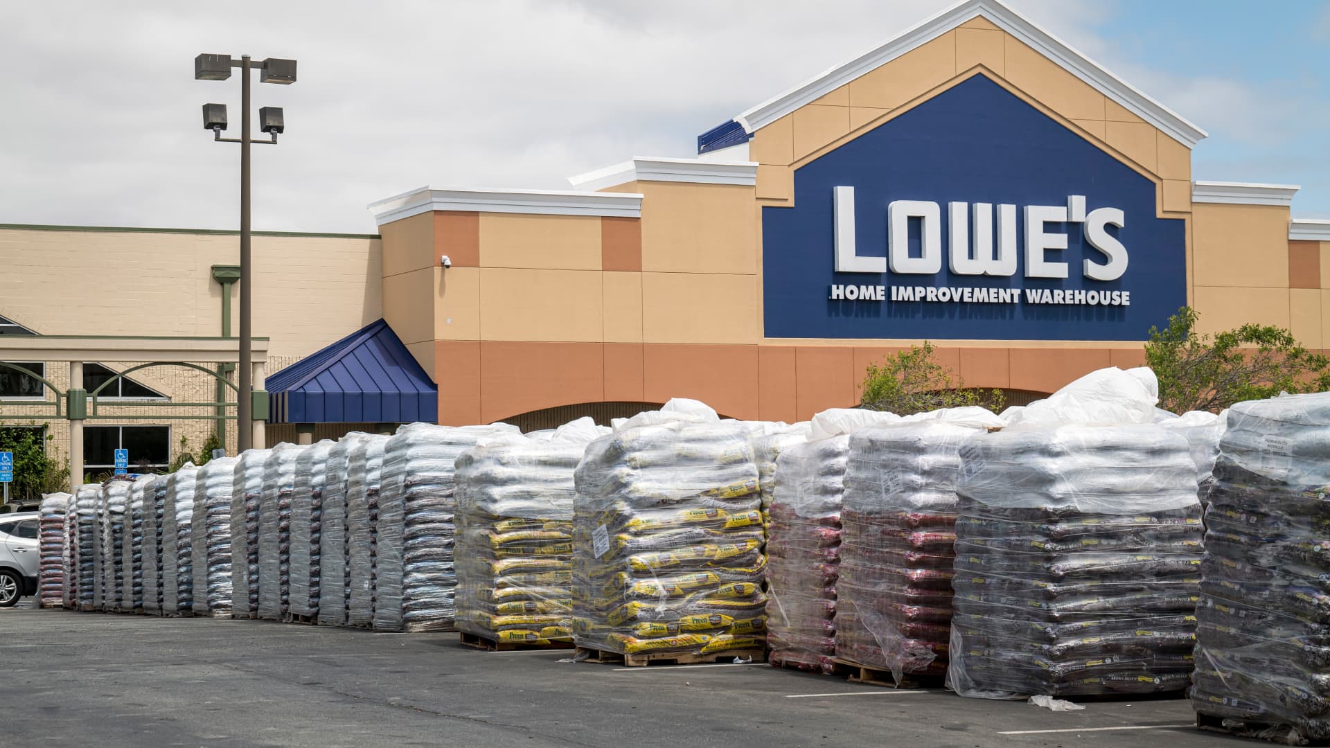Pallets of garden supplies sit stacked in the parking lot of a Lowe's store in San Bruno, California.