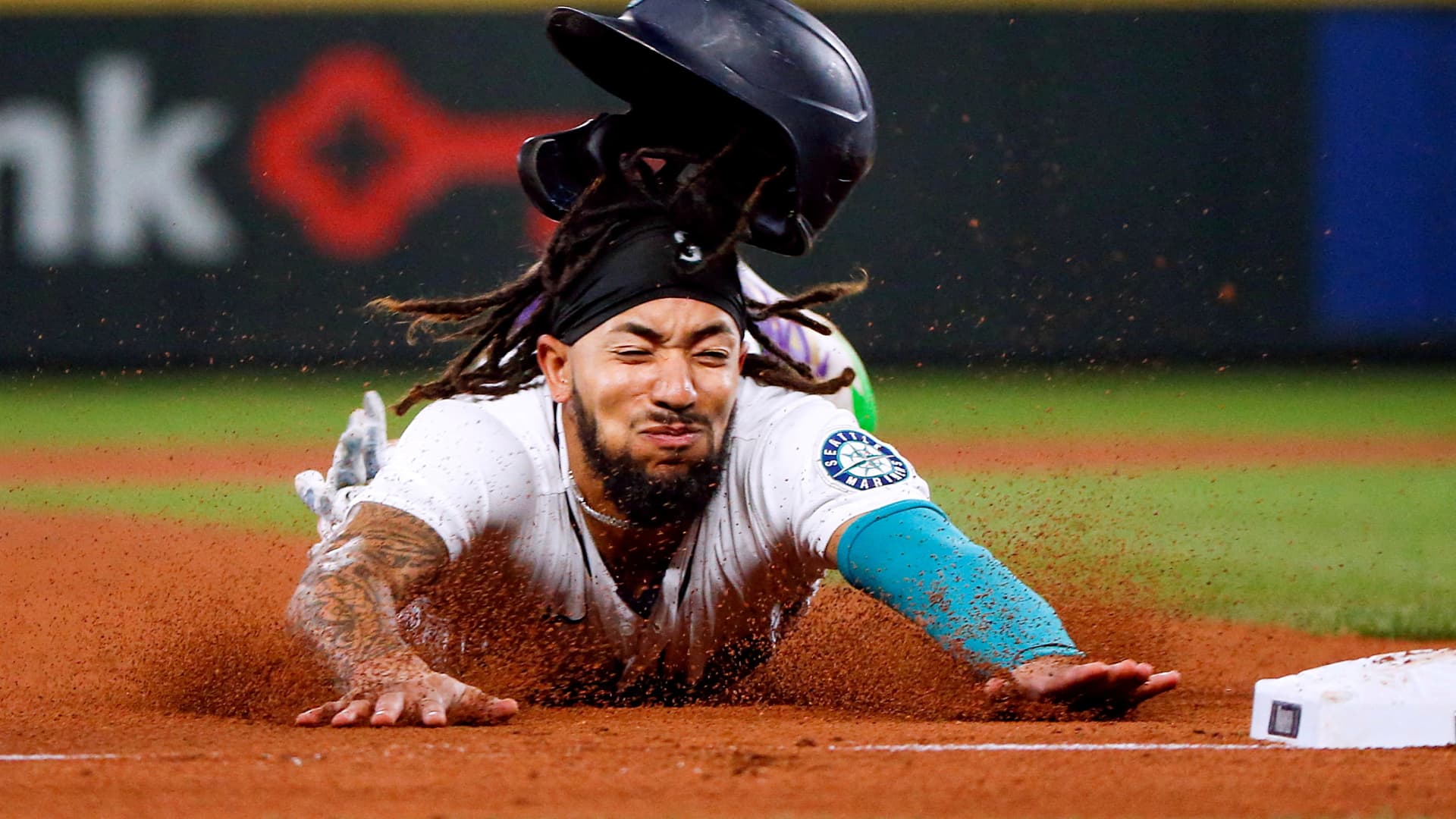 Seattle Mariners shortstop J.P. Crawford (3) slides into third to advance on a sacrifice fly against the Oakland Athletics during the third inning at T-Mobile Park, Sept. 28, 2021..