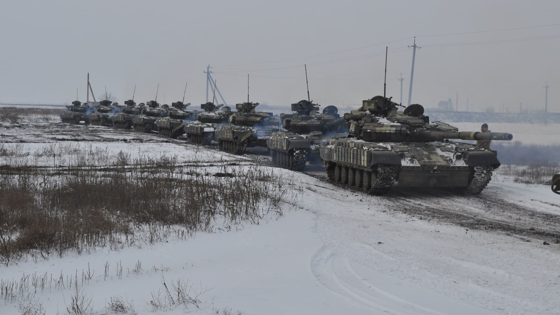Ukrainian tanks drive during tactical drills at a training ground in the Kherson region, Ukraine, in this handout picture released February 7, 2022.