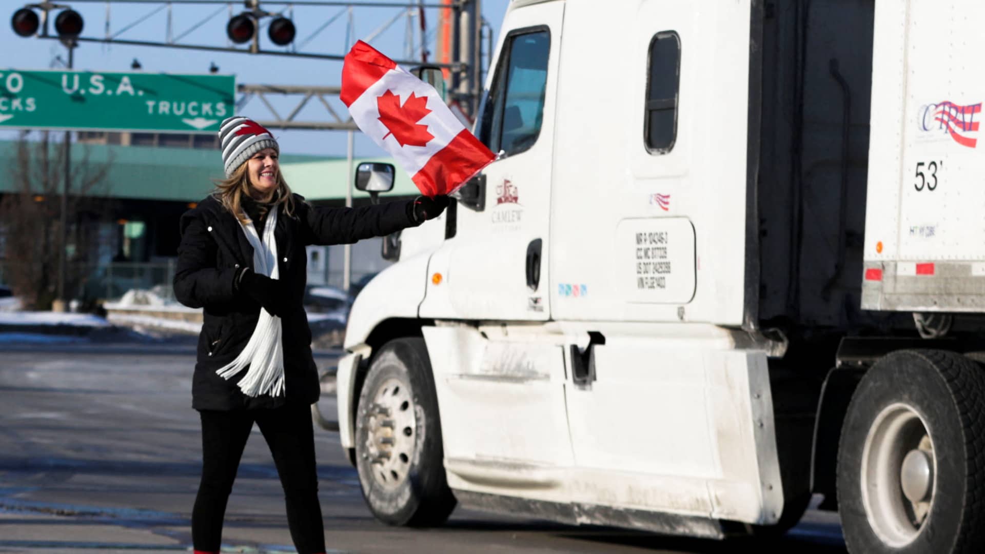 A woman attends a protest against the coronavirus disease (COVID-19) vaccine mandates, as vehicles block the route leading from the Ambassador Bridge linking Detroit and Windsor, in Windsor, Ontario, Canada February 8, 2022.