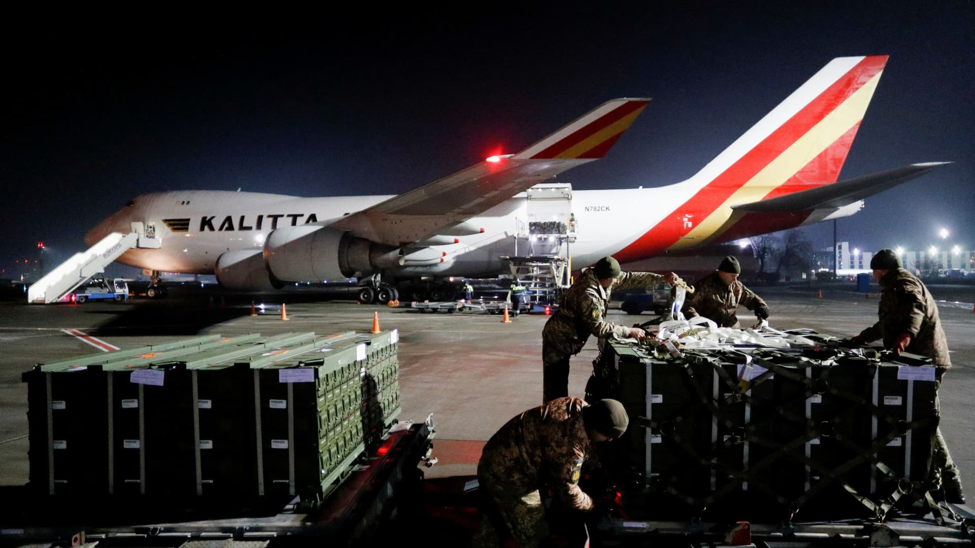 Ukrainian service members take part in the unloading of U.S. military aid, delivered by plane, as part of the security support package for Ukraine, at the Boryspil International Airport outside Kyiv, Ukraine February 10, 2022.