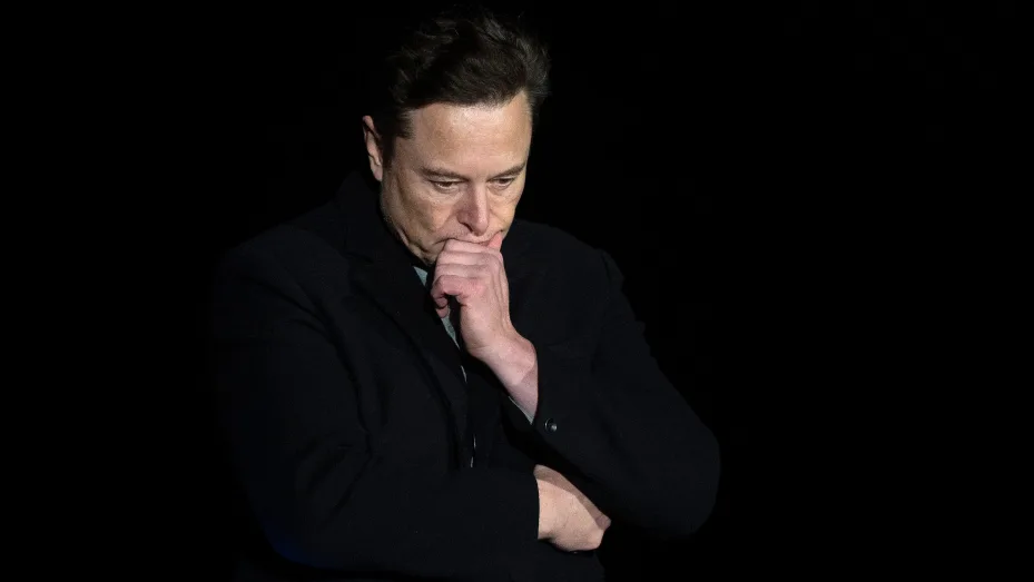 Elon Musk pauses and looks down as he speaks during a press conference at SpaceX's Starbase facility near Boca Chica Village in South Texas on February 10, 2022.