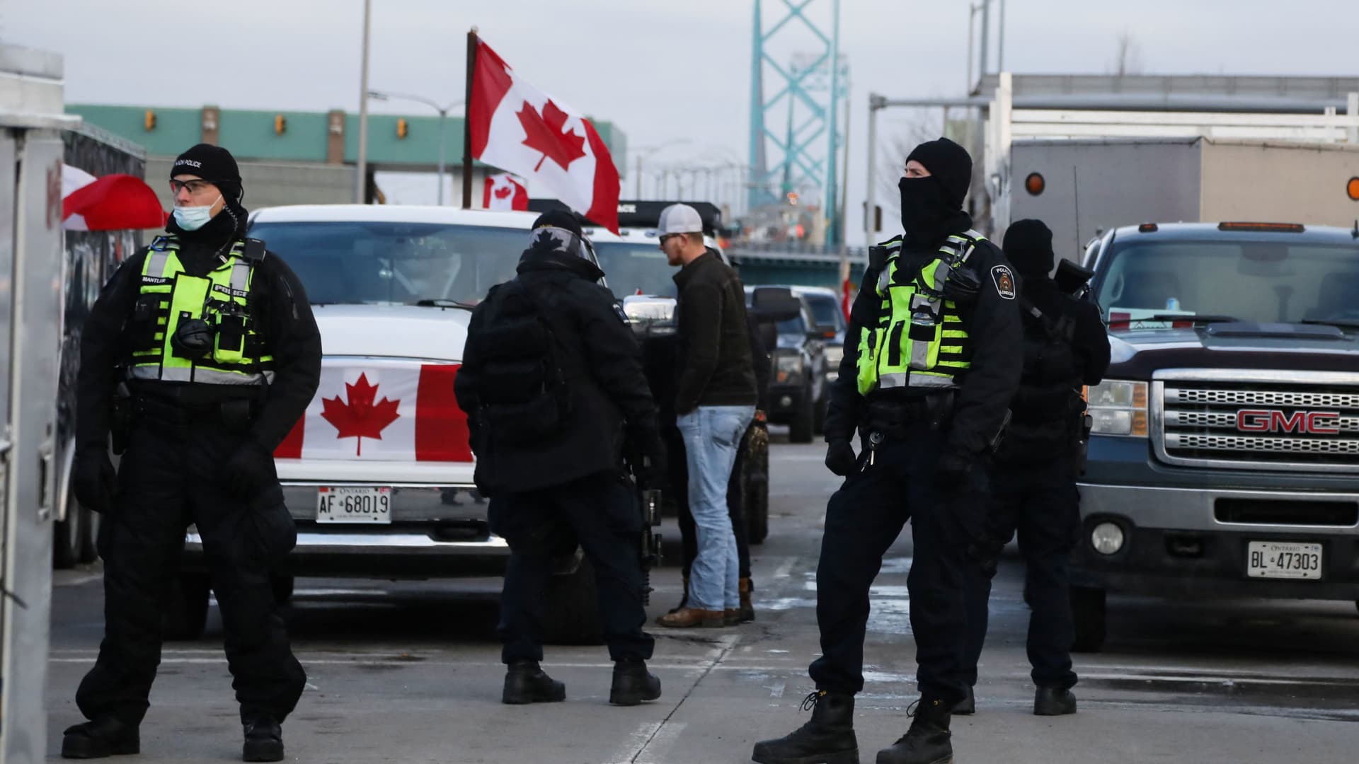 Police officers stand guard on a street as truckers and supporters continue blocking access to the Ambassador Bridge, which connects Detroit and Windsor, in protest against coronavirus disease (COVID-19) vaccine mandates, in Windsor, Ontario, Canada February 12, 2022.
