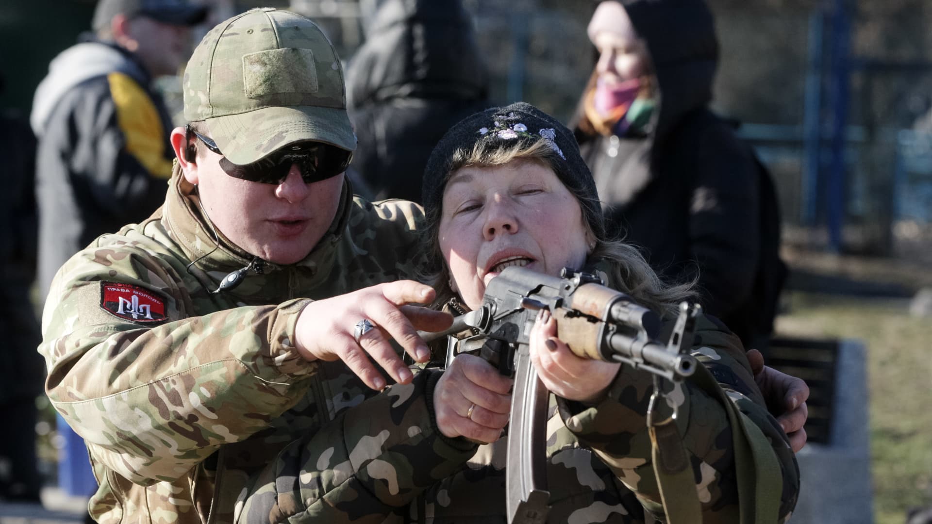 An 'Right Sector' instructor shows a civilian woman how to use an assault rifle Kalashnikov during a military exercise for territorial defense amid the tension on the border with Russia, in Ukrainian capital Kyiv, Ukraine 13 February 2022.