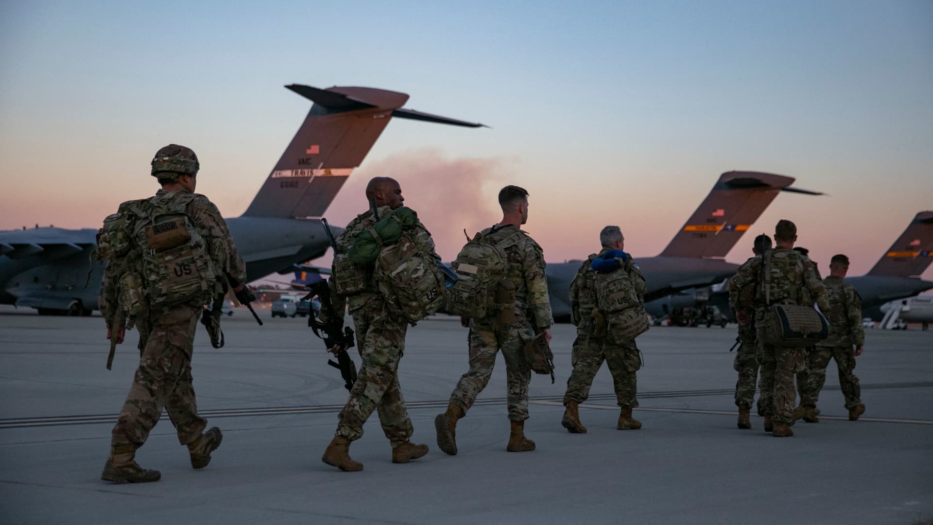 US soldiers walk to board a plane from Pope Army Airfield in Fort Bragg, North Carolina on February 14, 2021 as they are deployed to Europe.