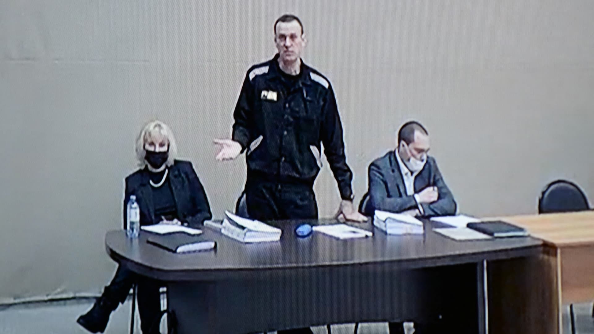 Russian opposition leader Alexei Navalny, lawyers Olga Mikhailova and Vadim Kobzev are seen on a screen via a video link during a court hearing at the IK-2 male correctional facility, in the town of Pokrov in Vladimir Region, Russia February 15, 2022.
