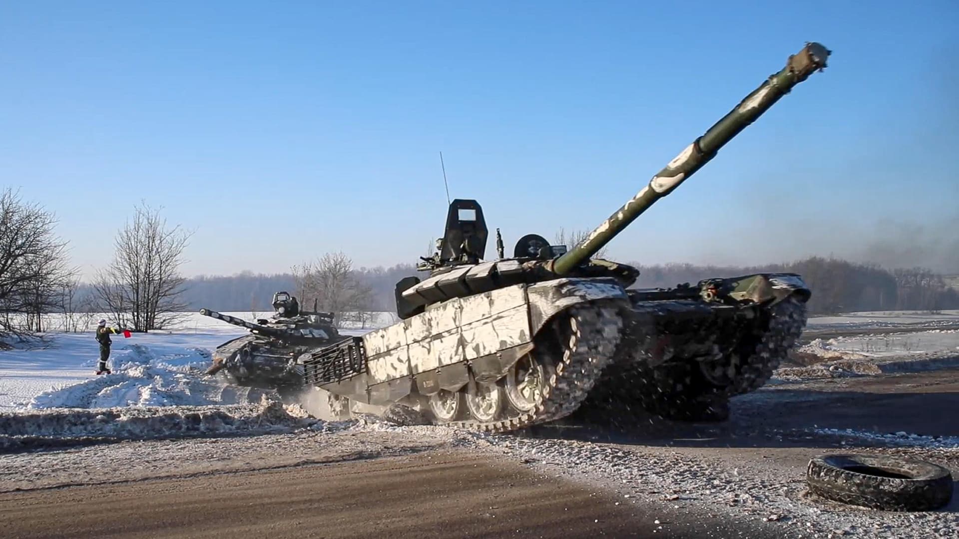 In this photo taken from video provided by the Russian Defense Ministry Press Service on Tuesday, Feb. 15, 2022, Russian army tanks move back to their permanent base after drills in Russia.