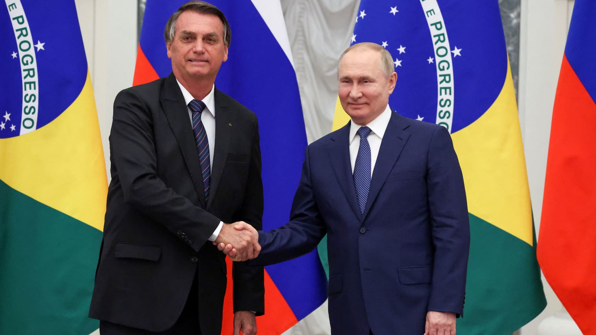 Russian President Vladimir Putin and his Brazilian counterpart Jair Bolsonaro shake hands during a news conference following their talks in Moscow, Russia February 16, 2022.