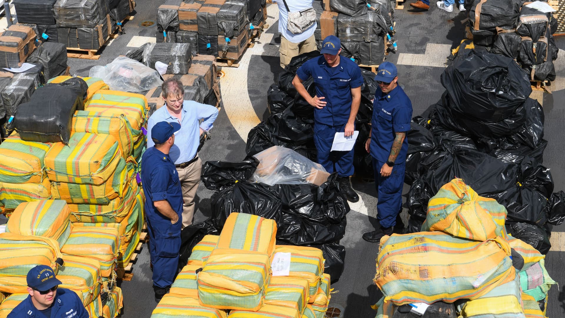 U.S. Coast Guard personnel stand on the deck of Cutter James as they offload approximately $1.06 billion in cocaine, marijuana at the Port Everglades in Fort Lauderdale, Florida on February 17, 2022.