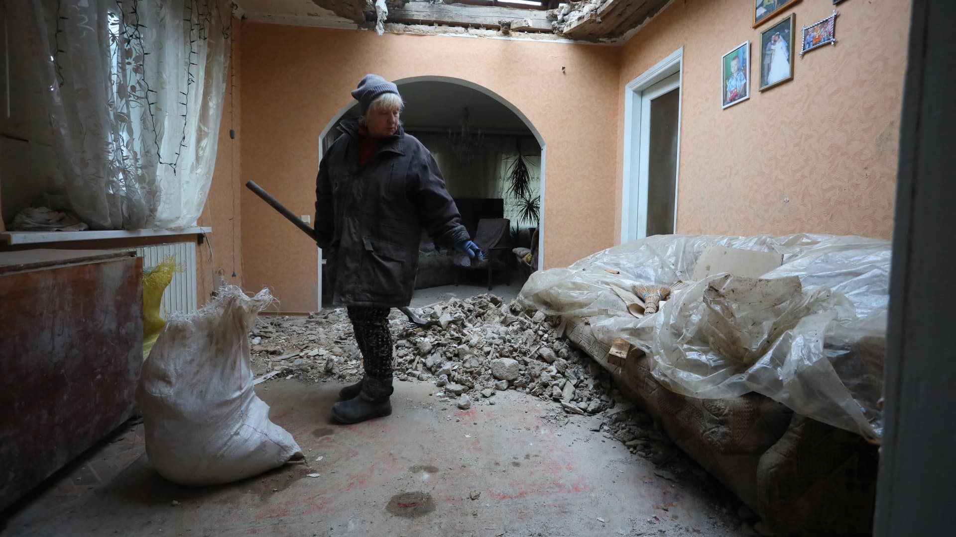 A local resident of the Ukrainian-controlled village of Stanytsia Luhanska, Luhansk region, cleans up debris from her home after the shelling by Russia-Backed separatists on February 18, 2022.
