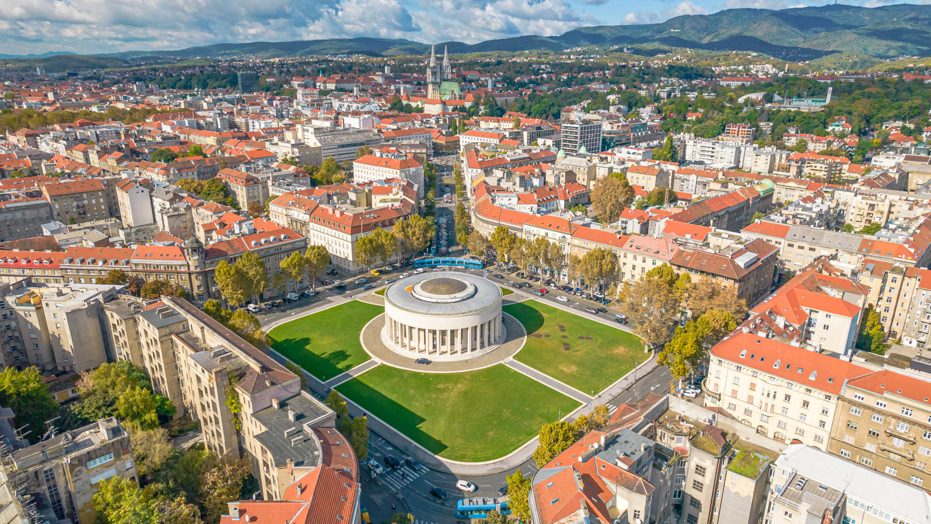 A shot of Zagreb, with the Meštrović Pavilion in the foreground and Medvednica Mountain as the backdrop.