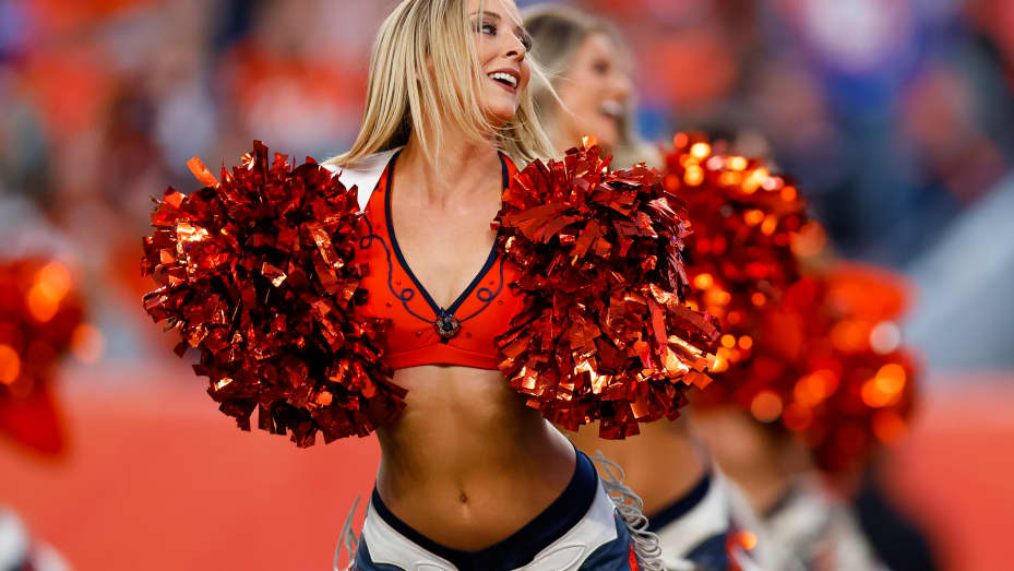 The denver broncos cheerleaders perform at a game against the la chargers at empower field.